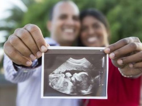 Happy Pregnant Couple Showing Ultrasound Picture